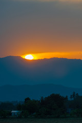 Golden light sunset behide the mountain in the evening