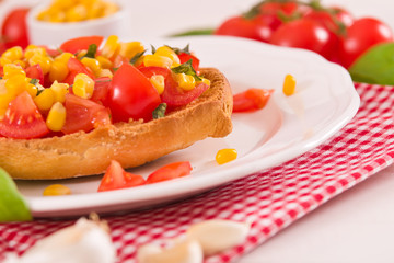 Friselle with tomatoes and mais.
