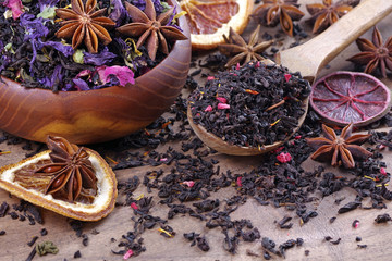blended tea with spices and dry citruses. black tea with dry flower petals. dry black tea leaves in...
