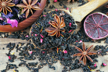 blended tea with spices and dry citruses. black tea with dry flower petals. dry black tea leaves in...