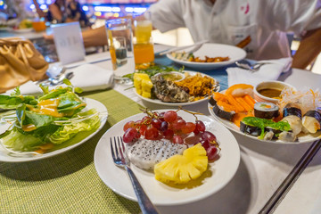 Vegetables, fruits and sushi on the table