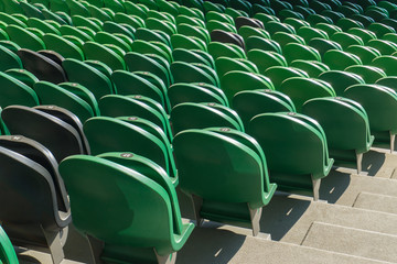 Obraz premium Empty plastic seats in a stadium. Matches to be played without fans.