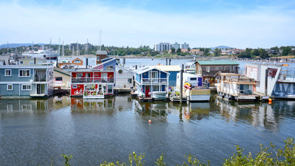 Fototapeta na wymiar Victoria city Inner Harbor landscape. Village of colorful floating houses. Fisherman Wharf in Victoria, Vancouver Island, Canada