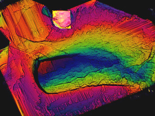 Crystal layer on microscope object glass, seen in polarized light. This causes random unforeseeable...