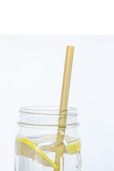 Lemon water and bamboo drinking straw.