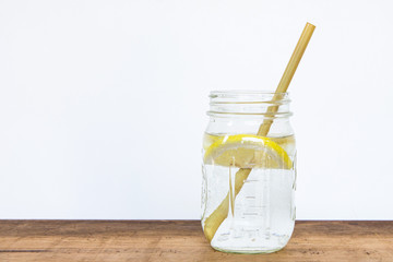 Lemon water and bamboo drinking straw.