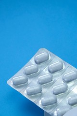 Pills in a blister pack  on a blue background.Health and medicine.Pills packing.Medical concept