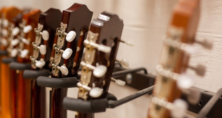 Close up of modern, wood guitar, view to instrument shop, music instrumental concept