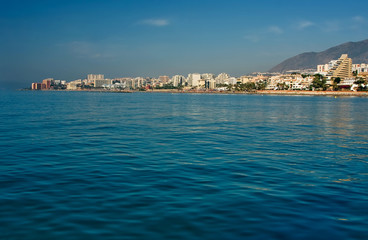 View from the sea ship to the city near the mountains