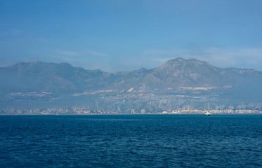 Fototapeta na wymiar Sea panorama of the city, fog and mountains