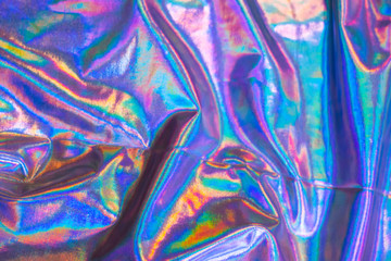 Holographic iridescent mermaid foil texture background. Futuristic neon trendy silver colors