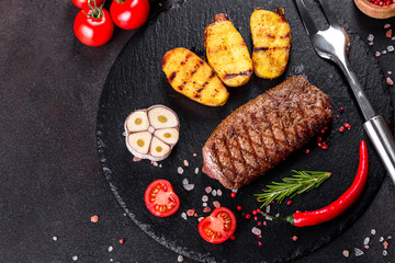 Ribeye steak with potatoes, onions and cherry tomatoes