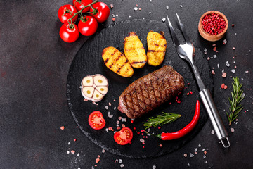 Ribeye steak with potatoes, onions and cherry tomatoes