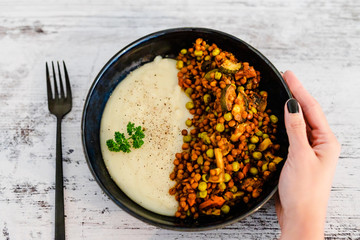 vegan lentils and potato mash dish with mixed veggies inspired by shepherd's pie