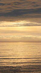 Yellow sunset on the Arctic Ocean in dark tones