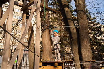 girls climb in rope Park in spring extreme sport