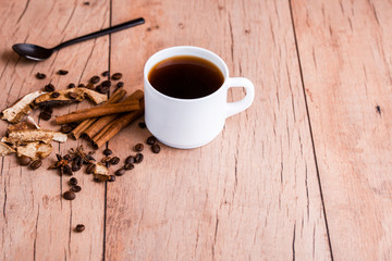 Fragrant natural coffee with cinnamon sticks and a black spoon.