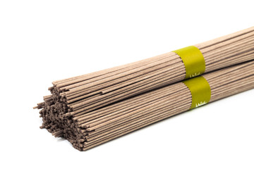 Dried raw japanese soba noodle sticks isolated on a white background. - Image