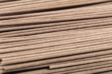 Dried raw japanese soba noodle sticks isolated on a white background. - Image