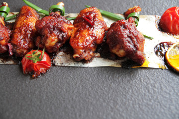  baked chicken wings with spices, tomato and soy sauce