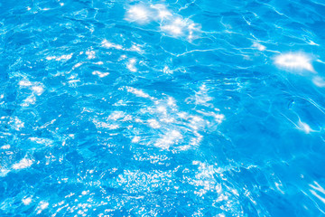 Blue and bright pool water with solar reflection, water ripple Movement and gentle wave in the pool