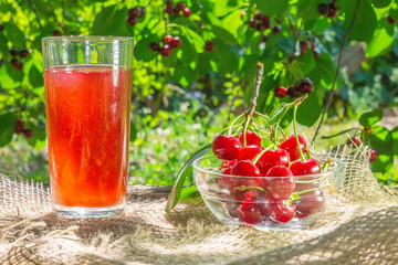 cherry berries with cherry juice on natural background. ripe sweet cherry harvest