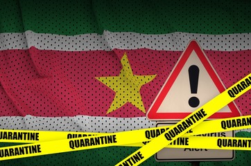 Suriname flag and Covid-19 quarantine yellow tape. Coronavirus or 2019-nCov virus
