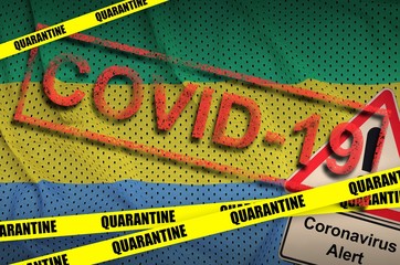 Gabon flag and Covid-19 quarantine yellow tape with red stamp. Coronavirus or 2019-nCov virus