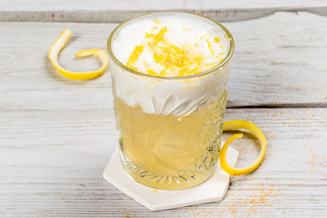 Cocktail with egg decorated with lemon zest.