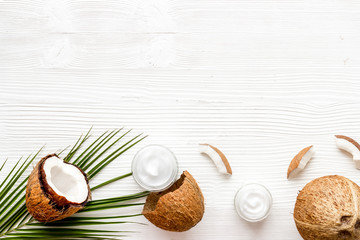 Fototapeta na wymiar Homemade coconut cream on white wooden background top-down frame copy space