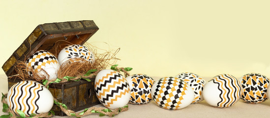 Easter vintage banner concept. Vintage chest and white eggs with yellow black colors on canvas with yellow background