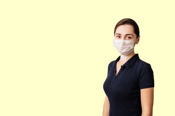 young clever woman with a medical mask on her face isolated on a yellow background