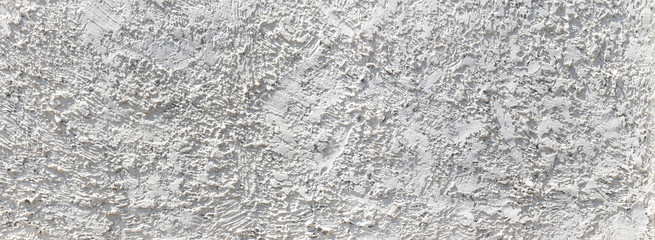 Panorama white cement wall with ragged and dirty surface texture. The old and broken rough white concrete wall background.