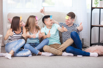 Group of young people playing games indoors. Active youth. Happy smiling people having fun. Students at the holidays.