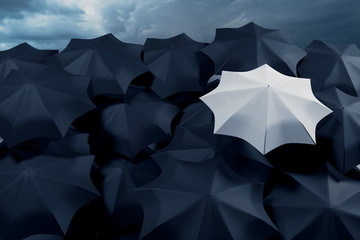 3D illustration of a large number of black umbrellas and one white against a stormy sky. Weather forecast - rains and showers.