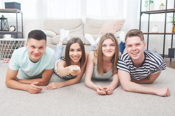 Group of young people watching tv. Emotional friends having fun and watching game indoors.