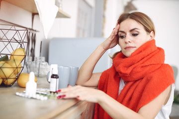 Theme of the disease. Woman at home. Woman in a red scarf.