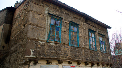 Fototapeta na wymiar Old Erzurum houses. Historical stone bazaar and ruined wooden houses.