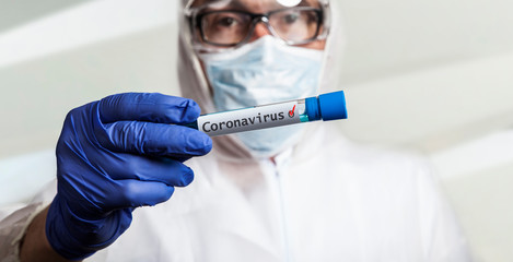 physician in laboratory holds SARS CoV 2 corona virus covid 19 in test tube