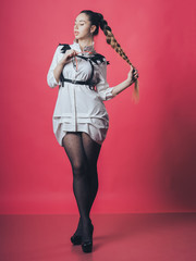 Brunette sexy girl posing at the pink background