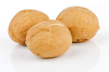 several raw walnuts isolated on white background