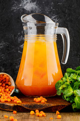 jug with sea buckthorn juice and mint © fusssergei