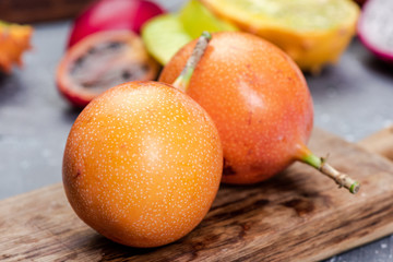 Granadilla or Grenadia Passionfruit Whole EXotic Fruits on Wooden Board