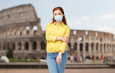 health, safety and pandemic concept - young woman wearing protective medical mask for protection from virus disease over coliseum in rome, italy background