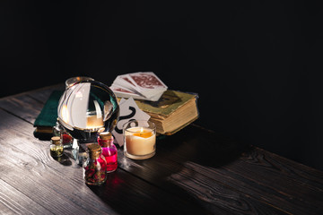 KYIV, UKRAINE - JANUARY 9, 2020: selective focus of occult objects on wooden and black background
