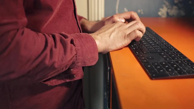 Young man touch typing on computer keyboard