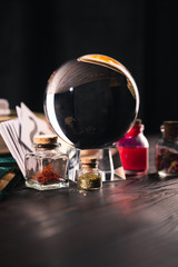 Selective focus of occult and mystical objects on wooden and black