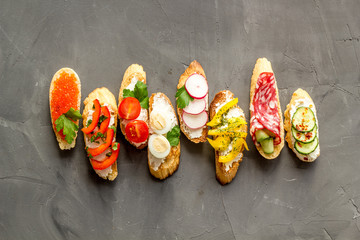 Sandwiches assorti pattern on grey background top-down