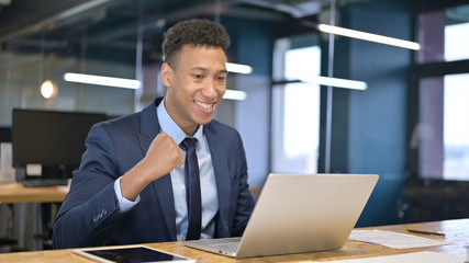 Businessman Celebrating Success on Laptop