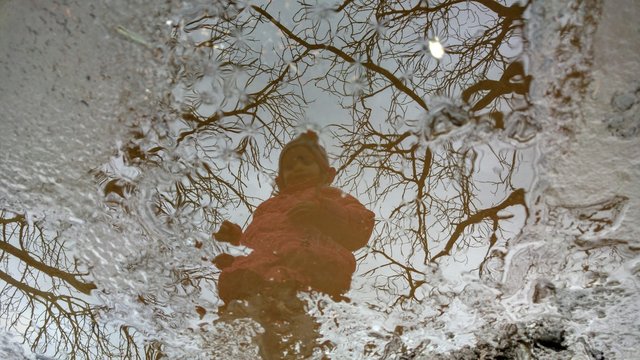 Reflection Of Girl On Puddle